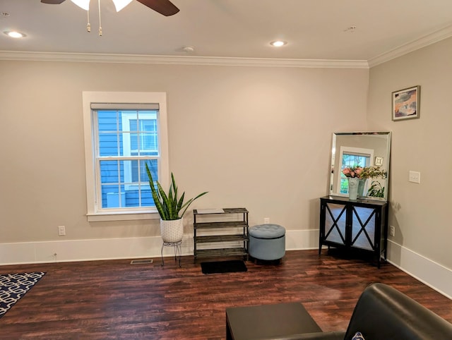 sitting room featuring ornamental molding, dark hardwood / wood-style floors, and ceiling fan