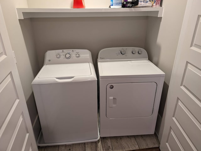 laundry room with hardwood / wood-style flooring and independent washer and dryer