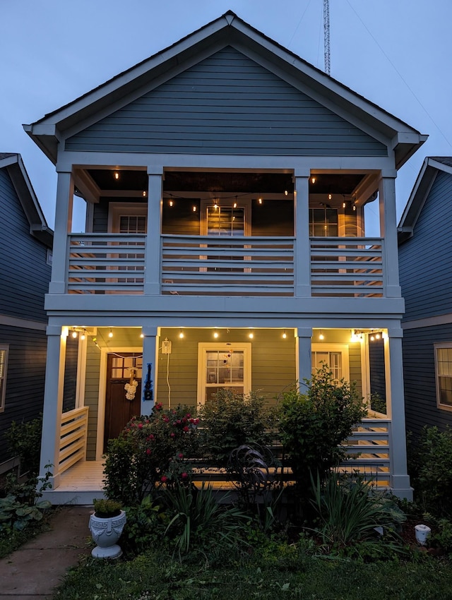 back of house featuring a balcony