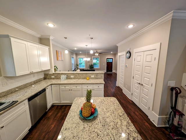 kitchen featuring pendant lighting, crown molding, dishwasher, white cabinets, and kitchen peninsula