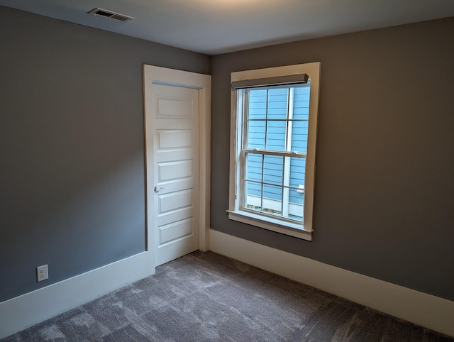 carpeted empty room featuring a healthy amount of sunlight