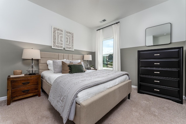 bedroom featuring light colored carpet, visible vents, and baseboards