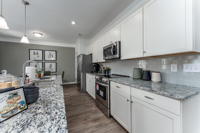 kitchen featuring appliances with stainless steel finishes, a sink, light stone countertops, and white cabinets