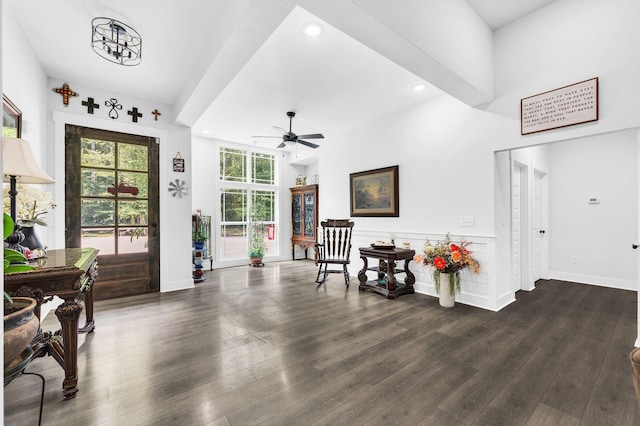 interior space featuring ceiling fan, dark hardwood / wood-style flooring, and a high ceiling