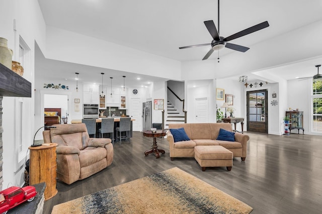 living room with ceiling fan and dark hardwood / wood-style flooring