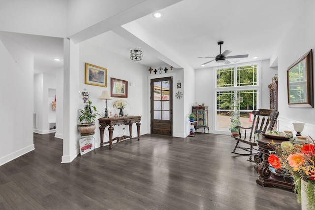 sitting room with dark wood-type flooring and ceiling fan