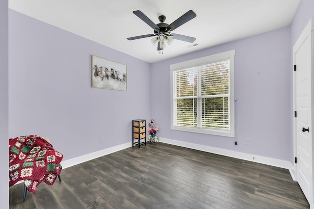 unfurnished room featuring ceiling fan and dark hardwood / wood-style flooring