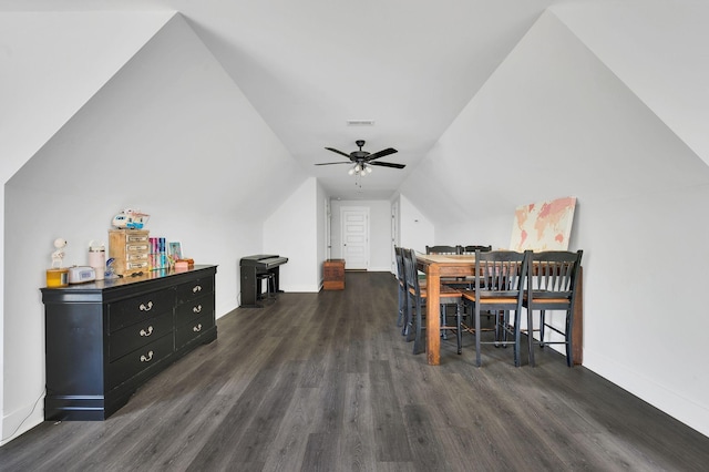 dining space featuring dark hardwood / wood-style flooring, vaulted ceiling, and ceiling fan