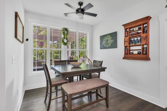 dining space with dark hardwood / wood-style flooring and ceiling fan