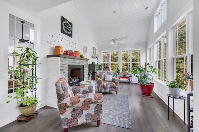 sunroom / solarium featuring ceiling fan, lofted ceiling, and a fireplace