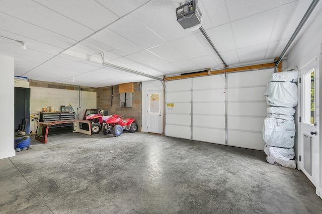 garage featuring a garage door opener and electric panel