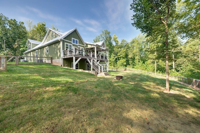 rear view of property featuring a yard and a deck