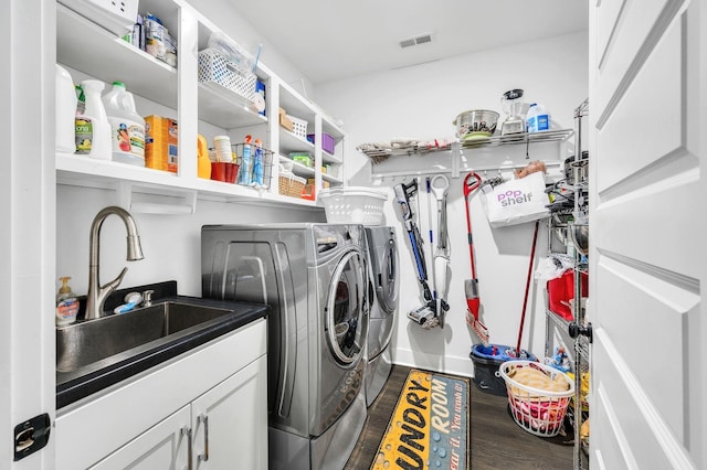 washroom with washer and dryer, sink, and dark hardwood / wood-style floors