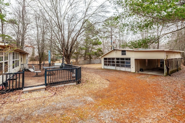 view of yard with a wooden deck and a carport