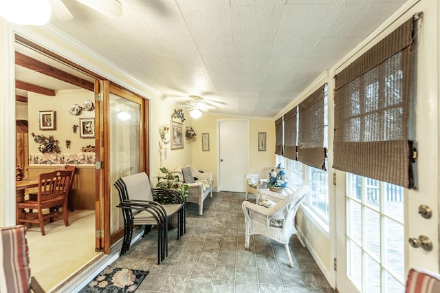 sunroom featuring ceiling fan