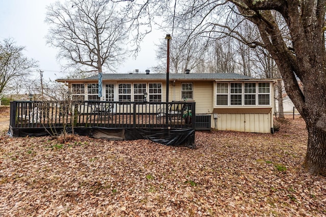 rear view of property with a wooden deck and central air condition unit