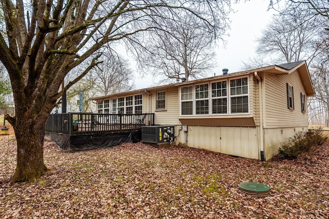 back of property with cooling unit and a deck