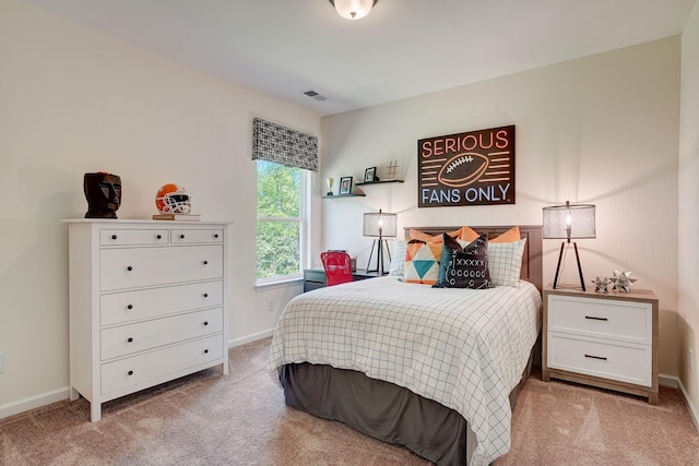 carpeted bedroom with visible vents and baseboards