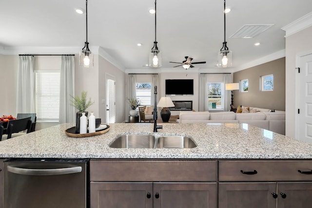 kitchen with crown molding, light stone counters, open floor plan, and dishwasher