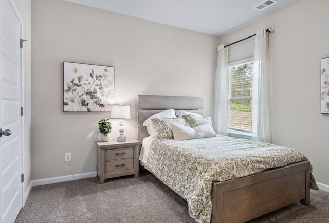 carpeted bedroom featuring visible vents and baseboards