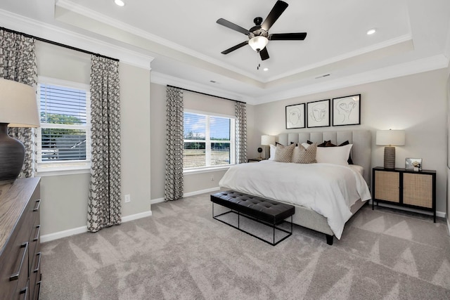 bedroom with light carpet, ornamental molding, and a raised ceiling