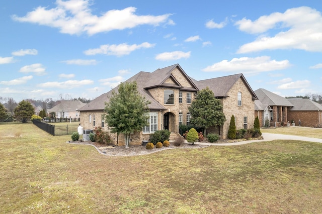 view of front of property featuring a front yard and central air condition unit