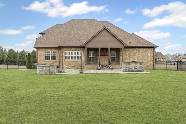 rear view of house featuring a yard and a patio area