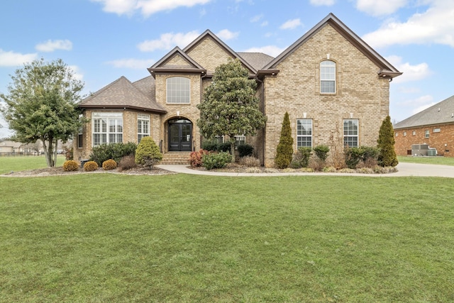 view of front facade with central AC unit and a front lawn