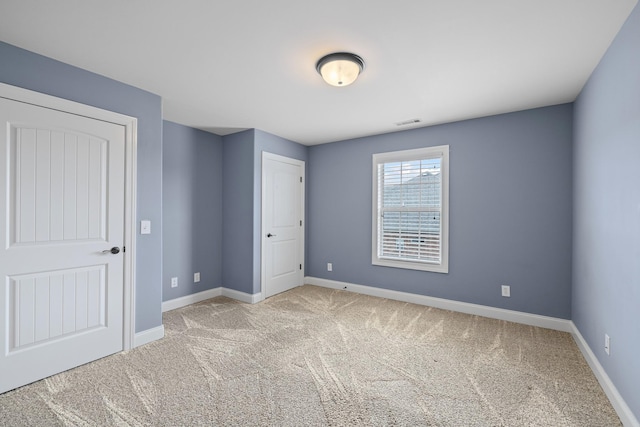 unfurnished bedroom with light colored carpet