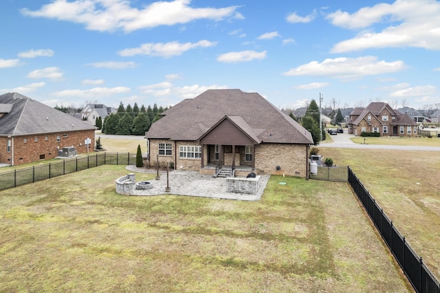 rear view of property with a lawn, a patio, and an outdoor fire pit