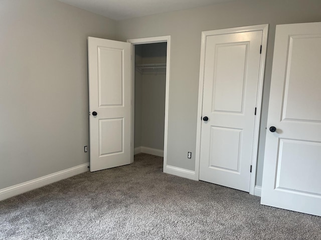 unfurnished bedroom with carpet floors and a closet