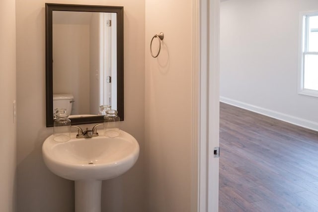 bathroom featuring sink, toilet, and hardwood / wood-style floors