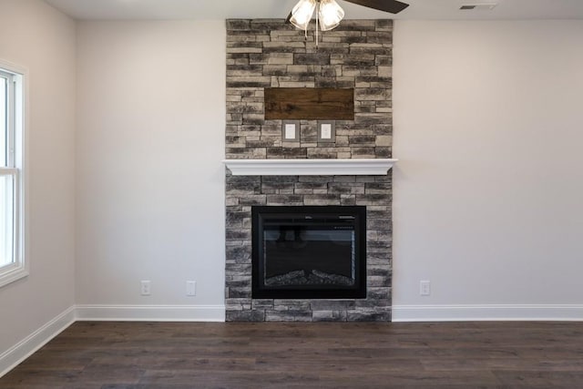 details featuring ceiling fan, a fireplace, and hardwood / wood-style floors