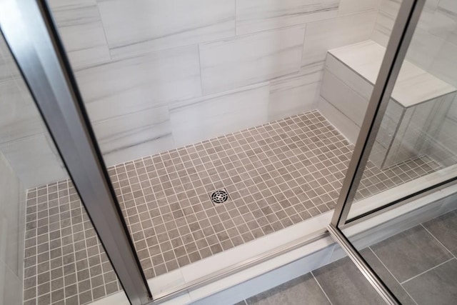 bathroom with a shower and tile patterned floors