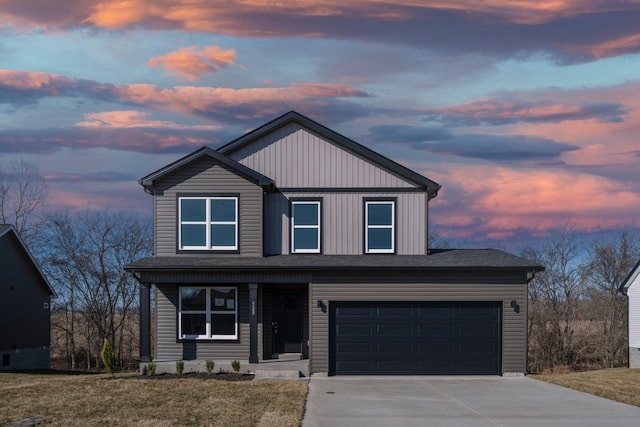 view of front of property with a garage and a yard