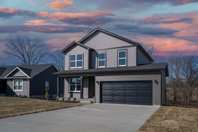 view of front of house with a garage and a lawn