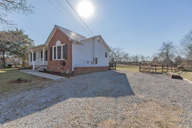 view of property exterior with a porch