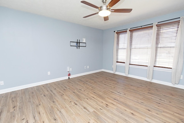 spare room with light hardwood / wood-style flooring and ceiling fan