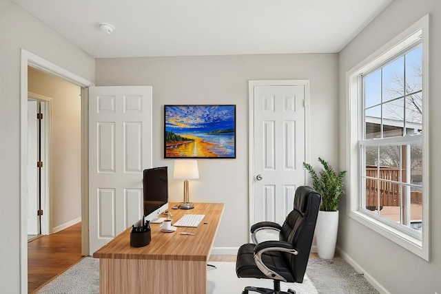 home office featuring baseboards and wood finished floors