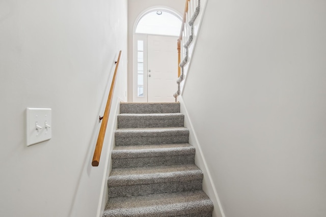 stairs featuring baseboards