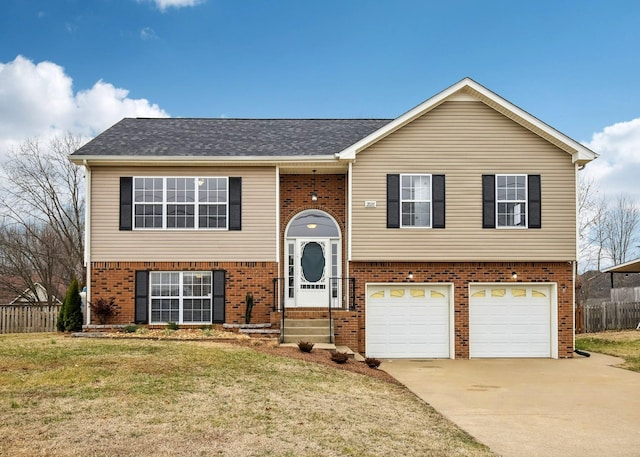 raised ranch with a garage and a front lawn