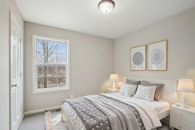 bedroom with carpet flooring and baseboards