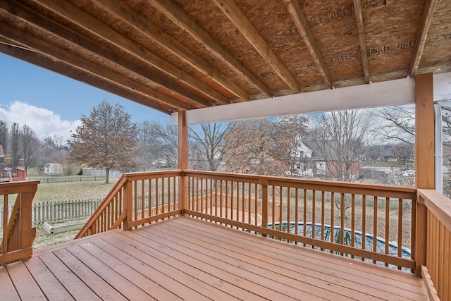 snow covered deck with a swimming pool and fence