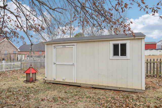 view of shed featuring fence