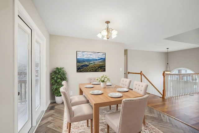 dining area with an inviting chandelier