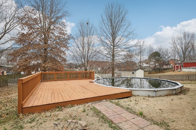 deck with fence and a fenced in pool