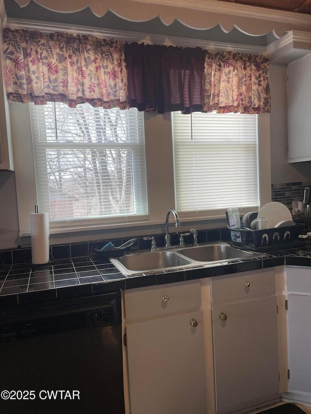 kitchen with white cabinetry, tile counters, dishwasher, and sink