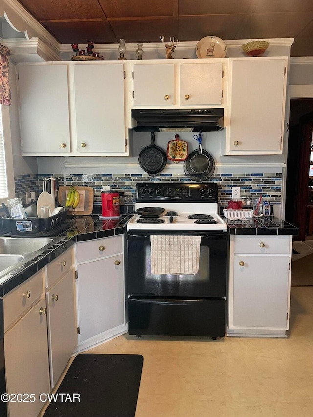 kitchen featuring range with electric stovetop, white cabinetry, sink, and decorative backsplash