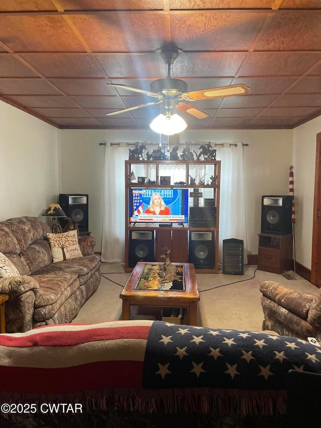 carpeted living room with ceiling fan