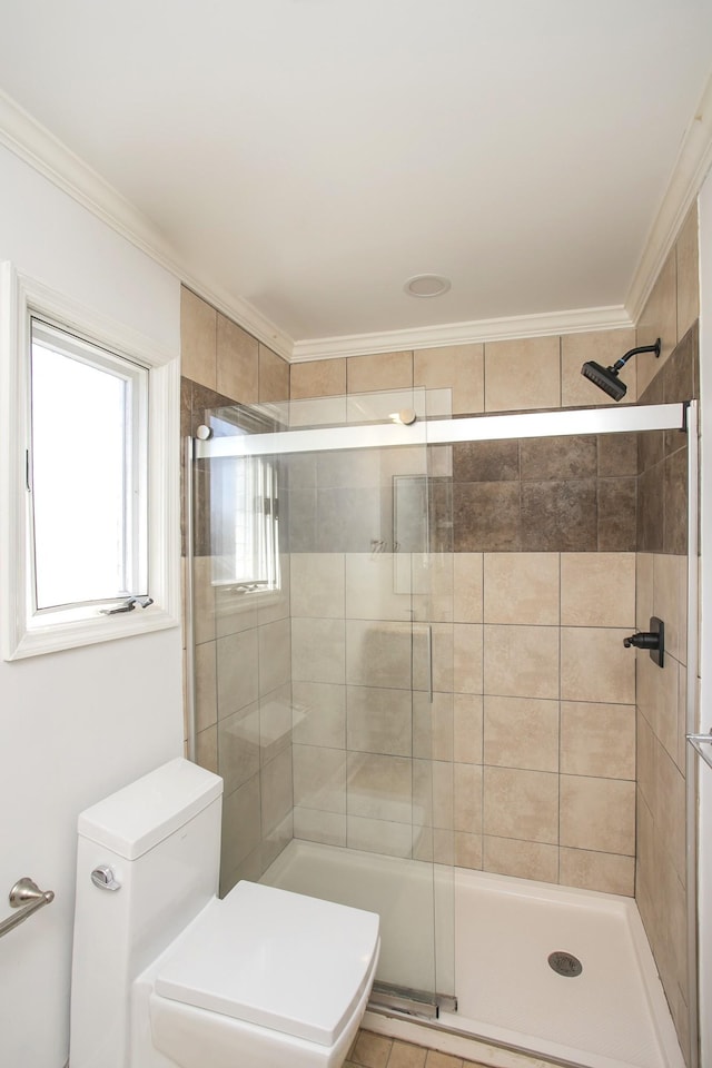 bathroom featuring crown molding, toilet, and walk in shower